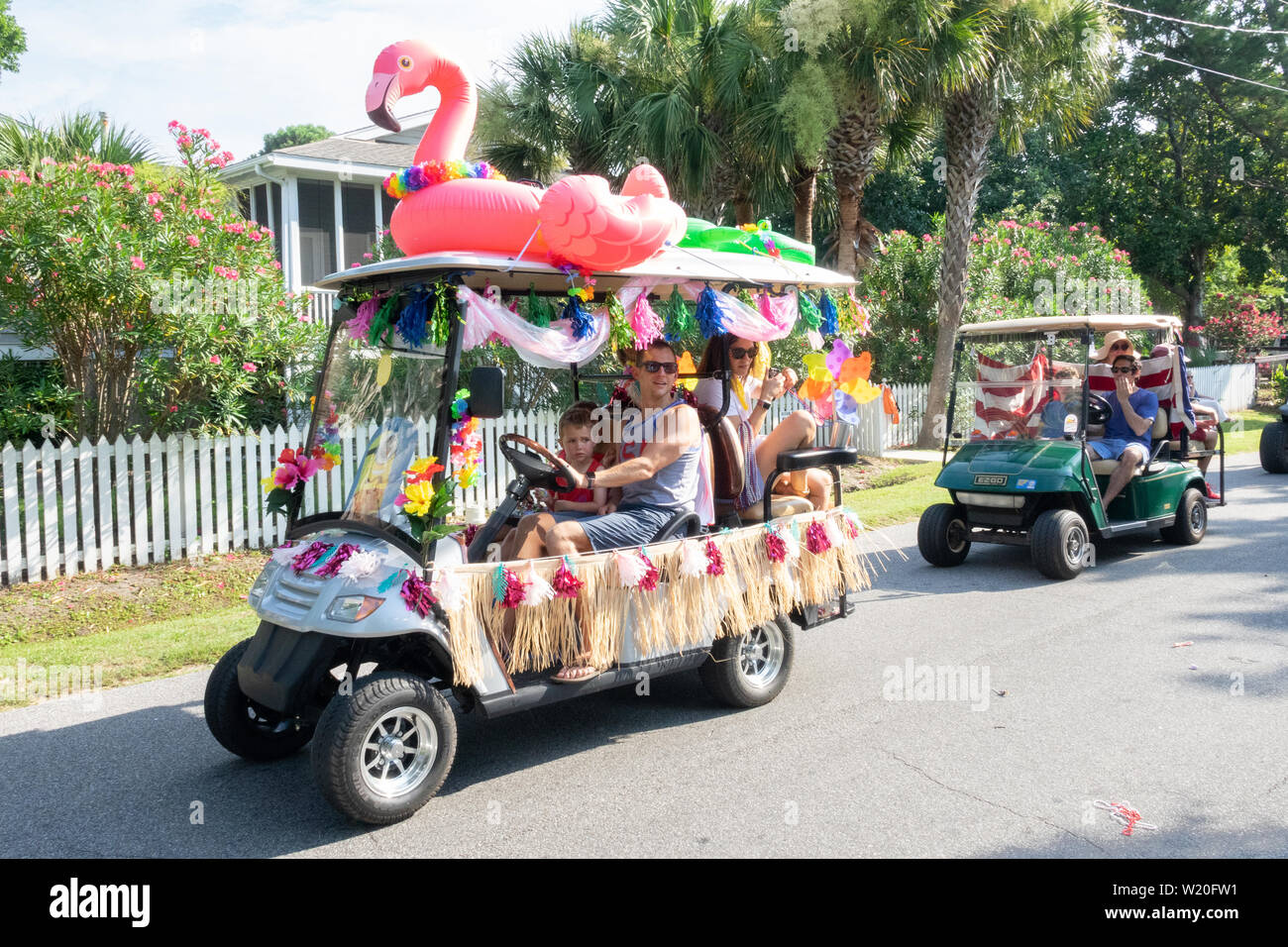 Golf cart floats decorated in tropical style during the annual Independence Day parade July 4, 2019 in Sullivan's Island, South Carolina. The tiny affluent Sea Island beach community across from Charleston holds an outsized golf cart parade featuring more than 75 decorated carts. Stock Photo