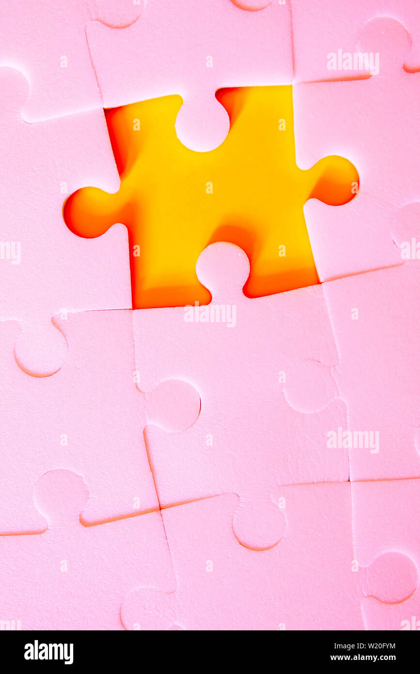 Multiple white puzzle pieces put together without one piece. View from above. Stock Photo