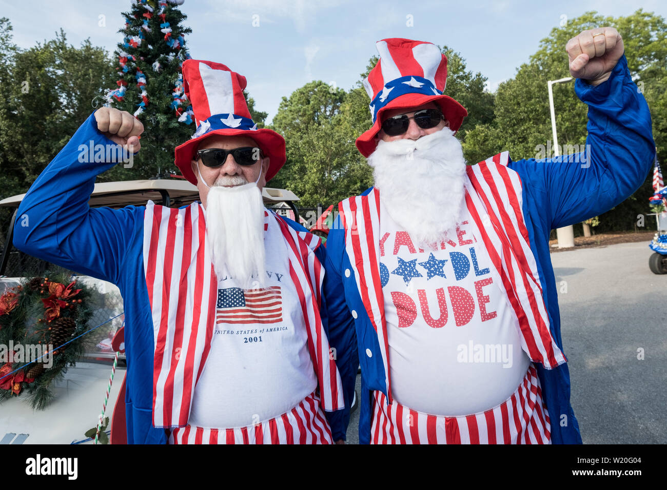 Men dressed in Uncle Sam costumes at the annual Independence Day golf cart and bicycle parade July 4, 2019 in Sullivan's Island, South Carolina. The tiny affluent Sea Island beach community across from Charleston holds an outsized golf cart parade featuring more than 75 decorated carts. Stock Photo