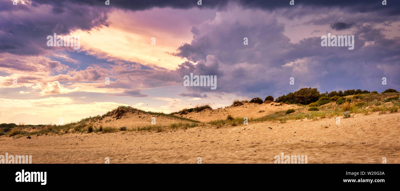Panoramic photo of dramatic cloudscape before storm on the beach. Majestic nature background. Stock Photo