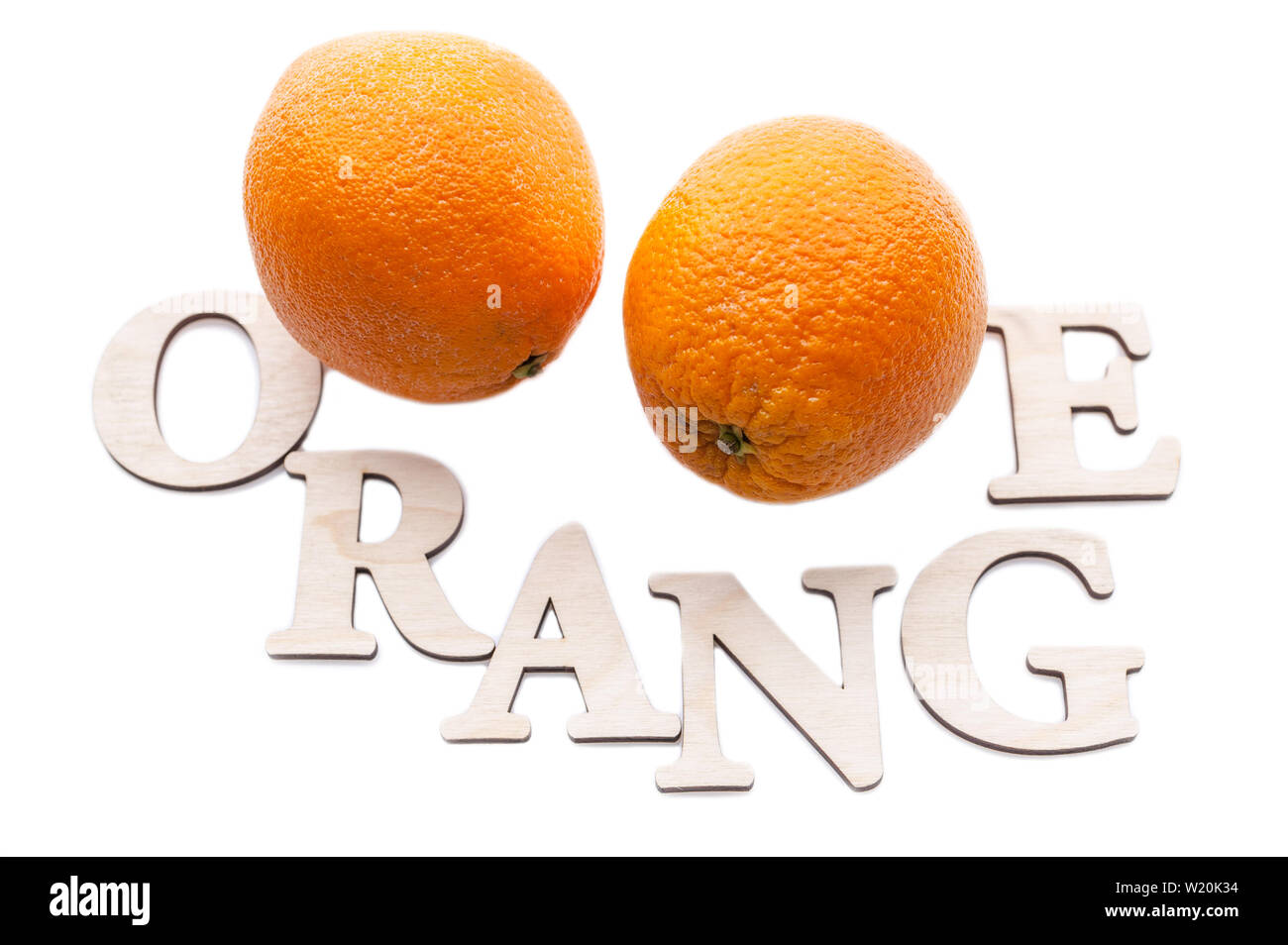 Top view two oranges and the word Orange. Isolated composition on white
