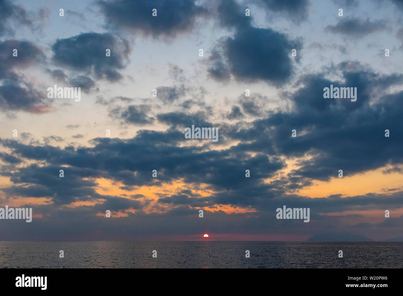 Picturesque sunset over Tyrrhenian Sea in Milazzo town, Sicily, Italy. Aeolian Islands (Italian: Isole Eolie), volcanic archipelago on the north of Si Stock Photo