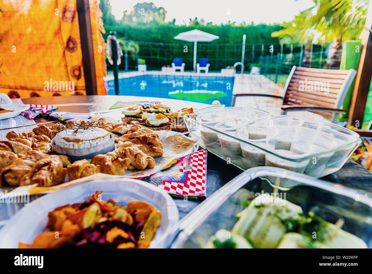 A copious snack served by the pool during the summer holidays Stock Photo Alamy