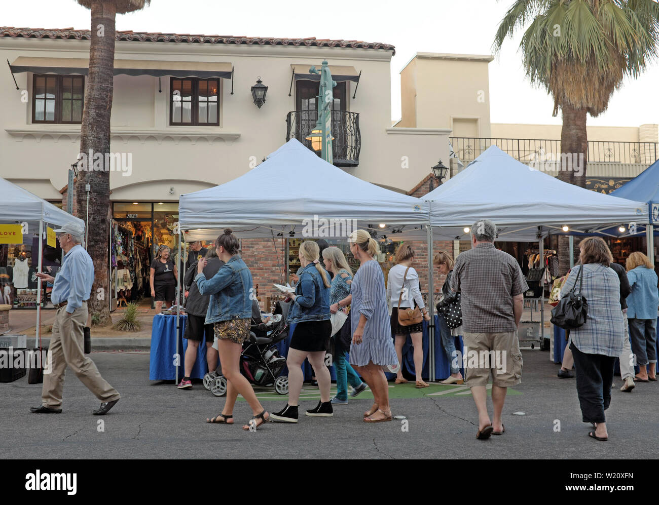 People enjoy the Villagefest in downtown Palm Springs, California. The Thursday night street fair features arts, crafts, food, and entertainment. Stock Photo