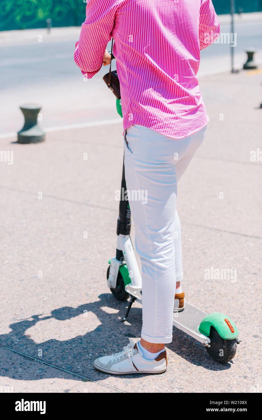 Close up view of legs of man on electric scooter outdoor Stock Photo