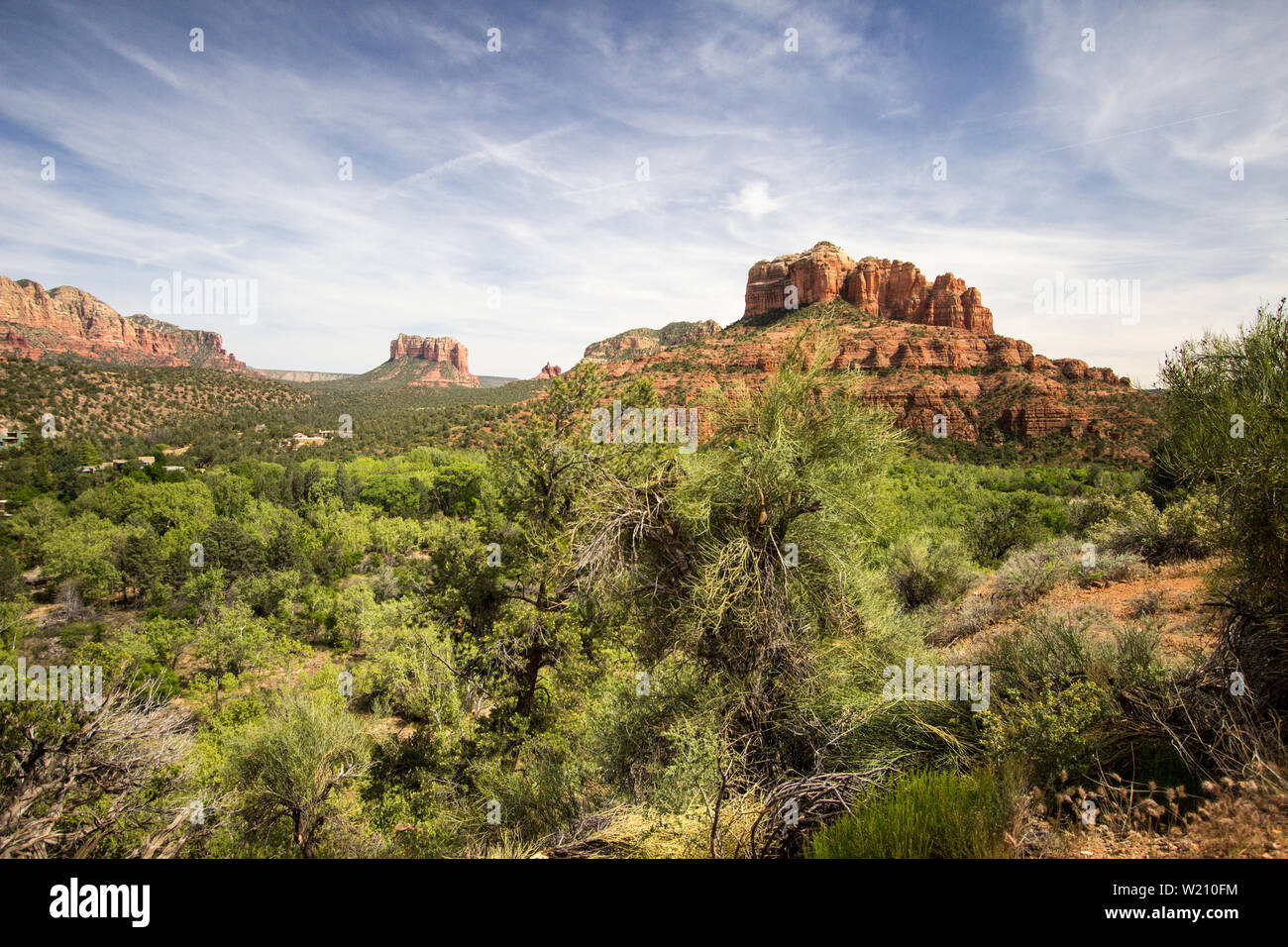 Red Rocks Of Sedona. Scenic Sedona, Arizona red rock landscape with the famous Courthouse and Bell mountain geological formations under a  blue sky. Stock Photo