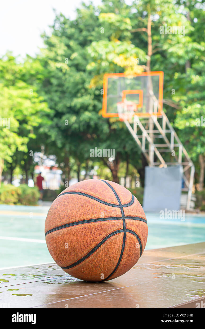 Basketball leather on the wooden chair with water droplets Background