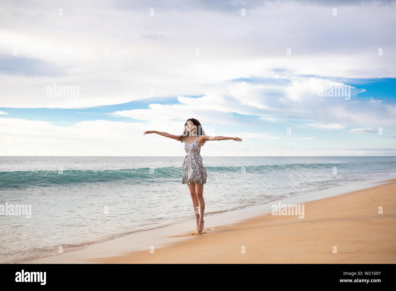 Woman dancing on beach hi-res stock photography and images - Alamy