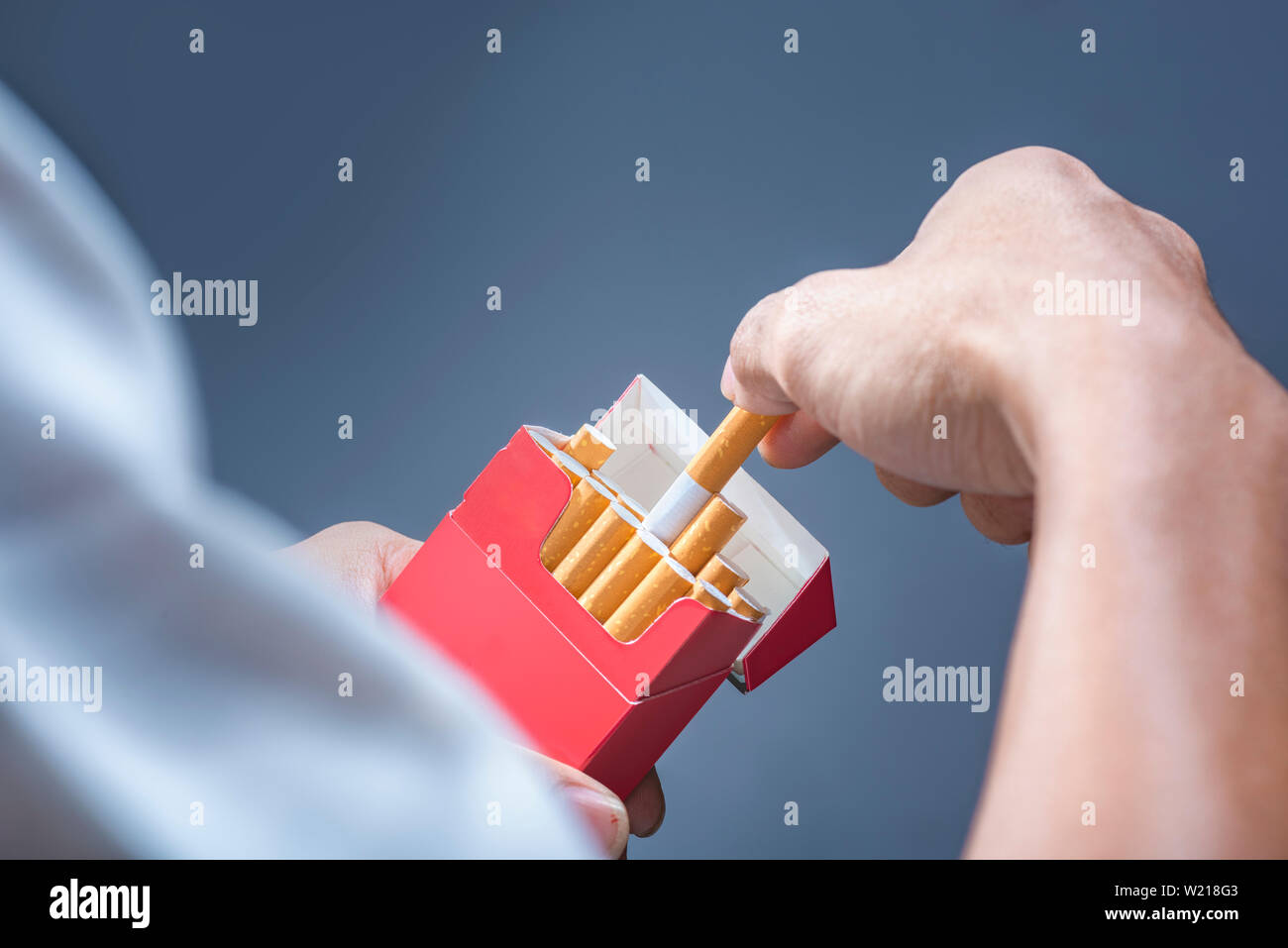 hand holding a box of cigarettes cigarette pack Female Hand Holding Pack On A White Background Isolation Hand holding cigarette pack Images