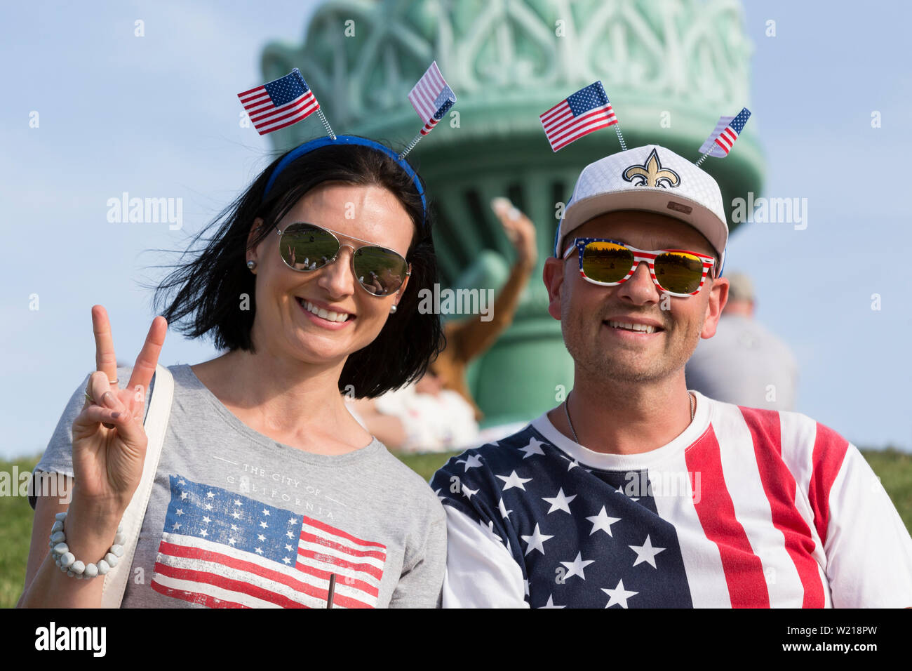 A couple from the United Kingdom in patriotic American garb pose for a photo at the Seafair Summer Fourth Independence Day Celebration at Gas Works Park on July 4, 2019 in Seattle, Washington. Stock Photo