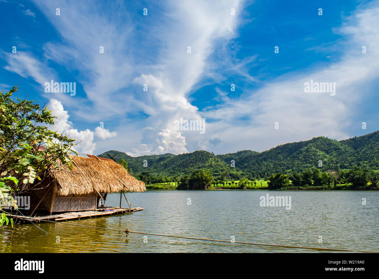 The wooden raft in the water reservoirs and mountain views. Stock Photo