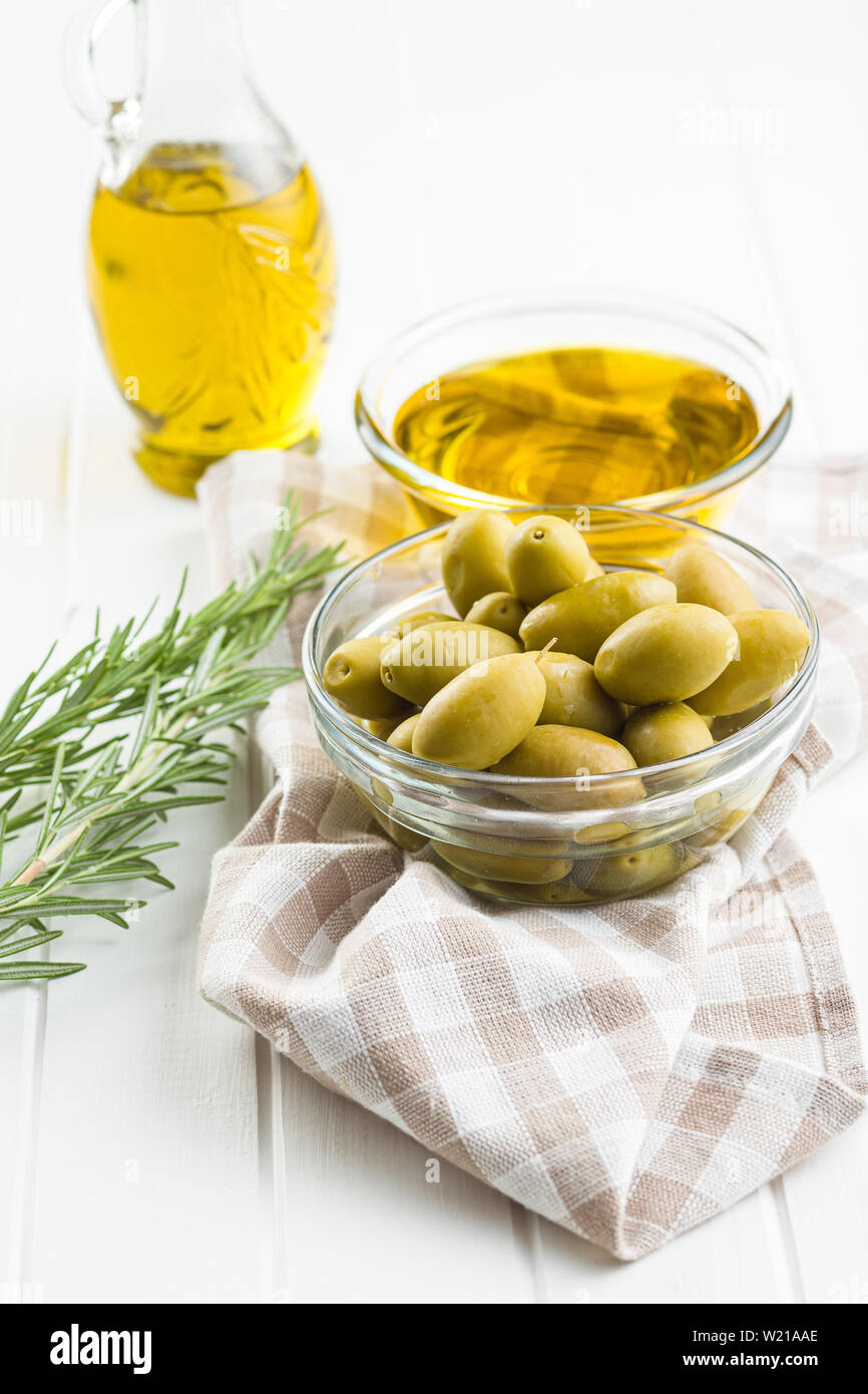 Green olives and olive oil in glass bowl on checkered napkin Stock ...