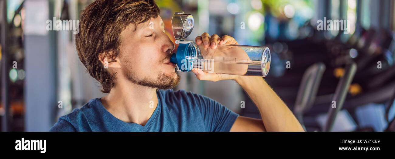 Sport man drinking water in the gym BANNER, LONG FORMAT Stock Photo - Alamy