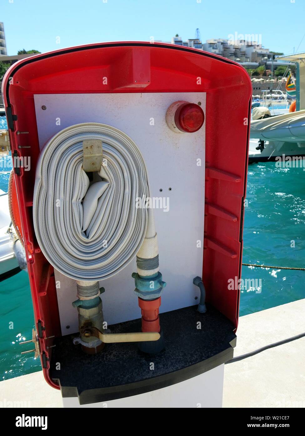 Fire hose reel at a marina. Stock Photo