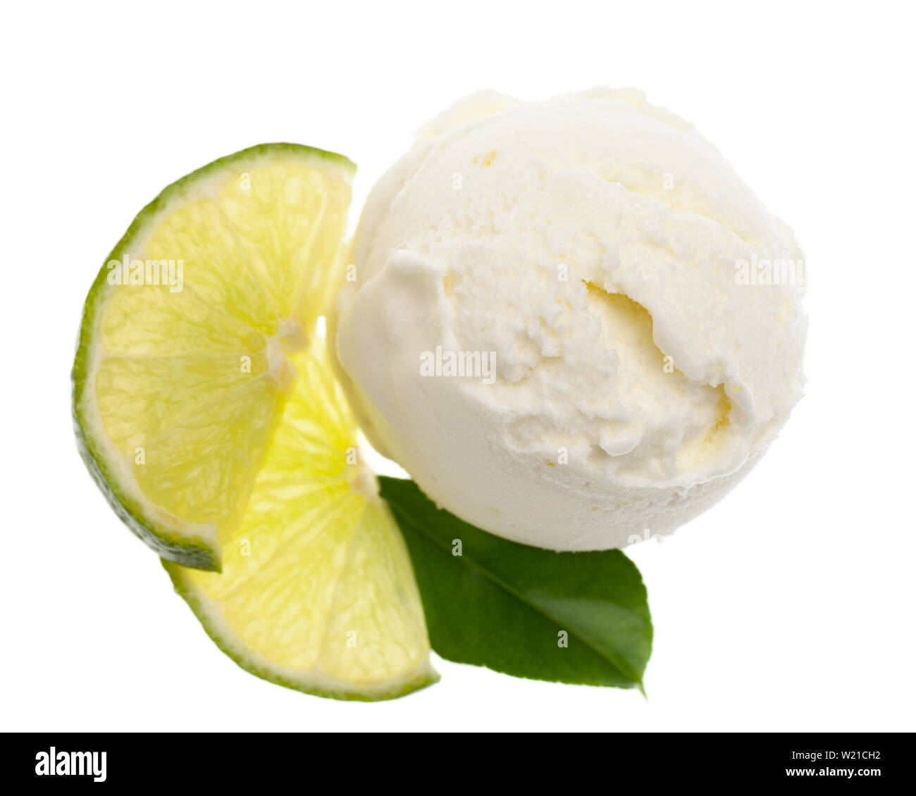 bird´s eye view of lemon ice cream scoop with slices of lemon and a single lemon leaf isolated on white background Stock Photo