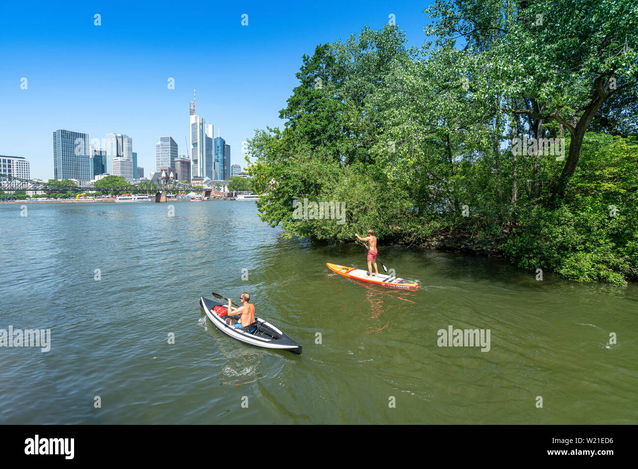 Frankfurt, Germany. July 2019.   Some canoeists on the river Main with the skyline of the city in the background Stock Photo