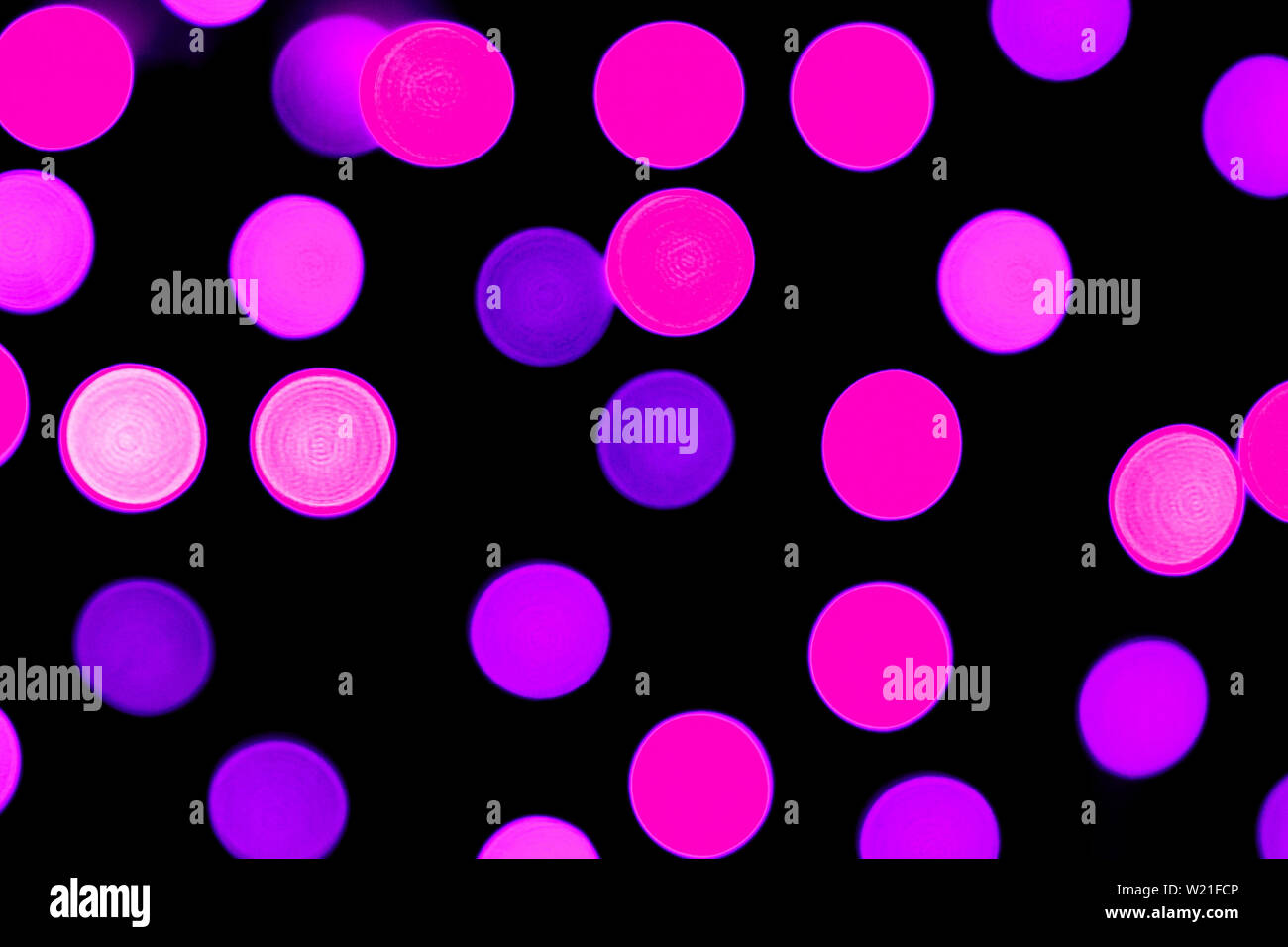 Unfocused abstract purple bokeh on black background. defocused and ...