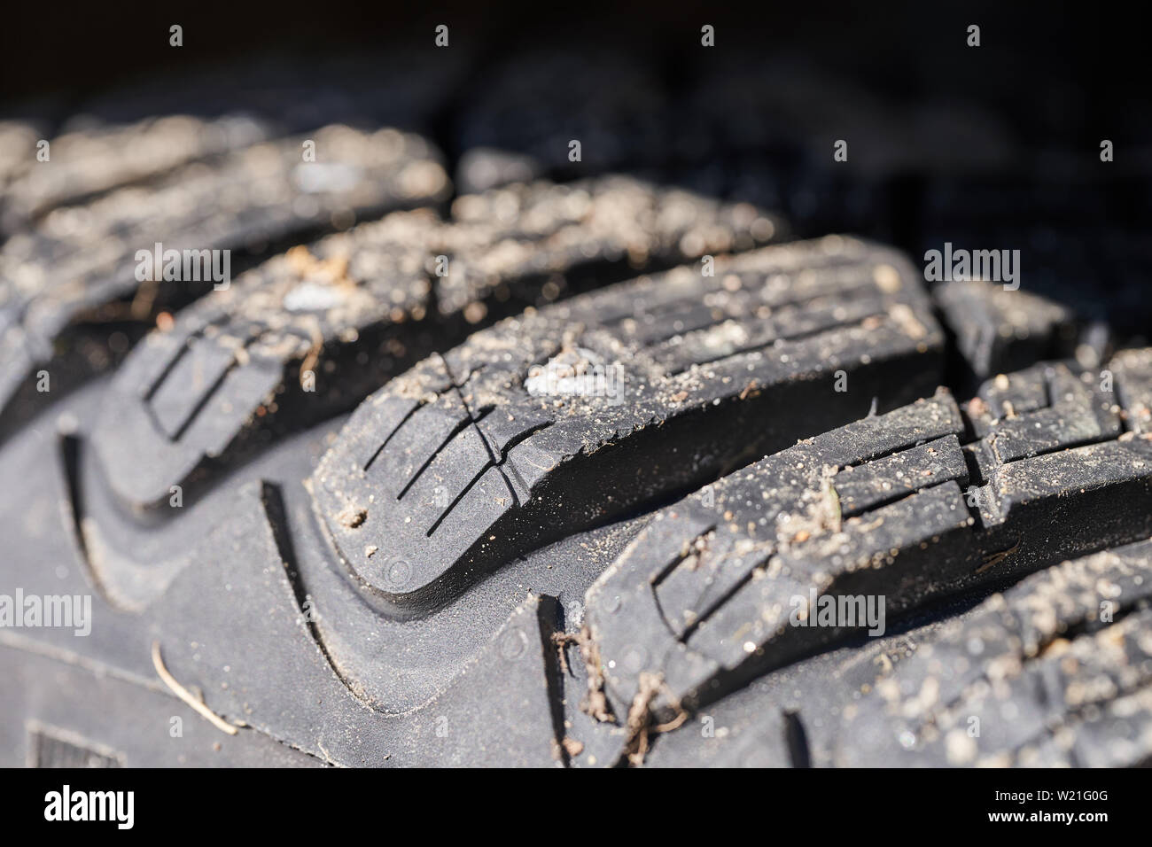 Car tire tread with spikes close up. Stock Photo