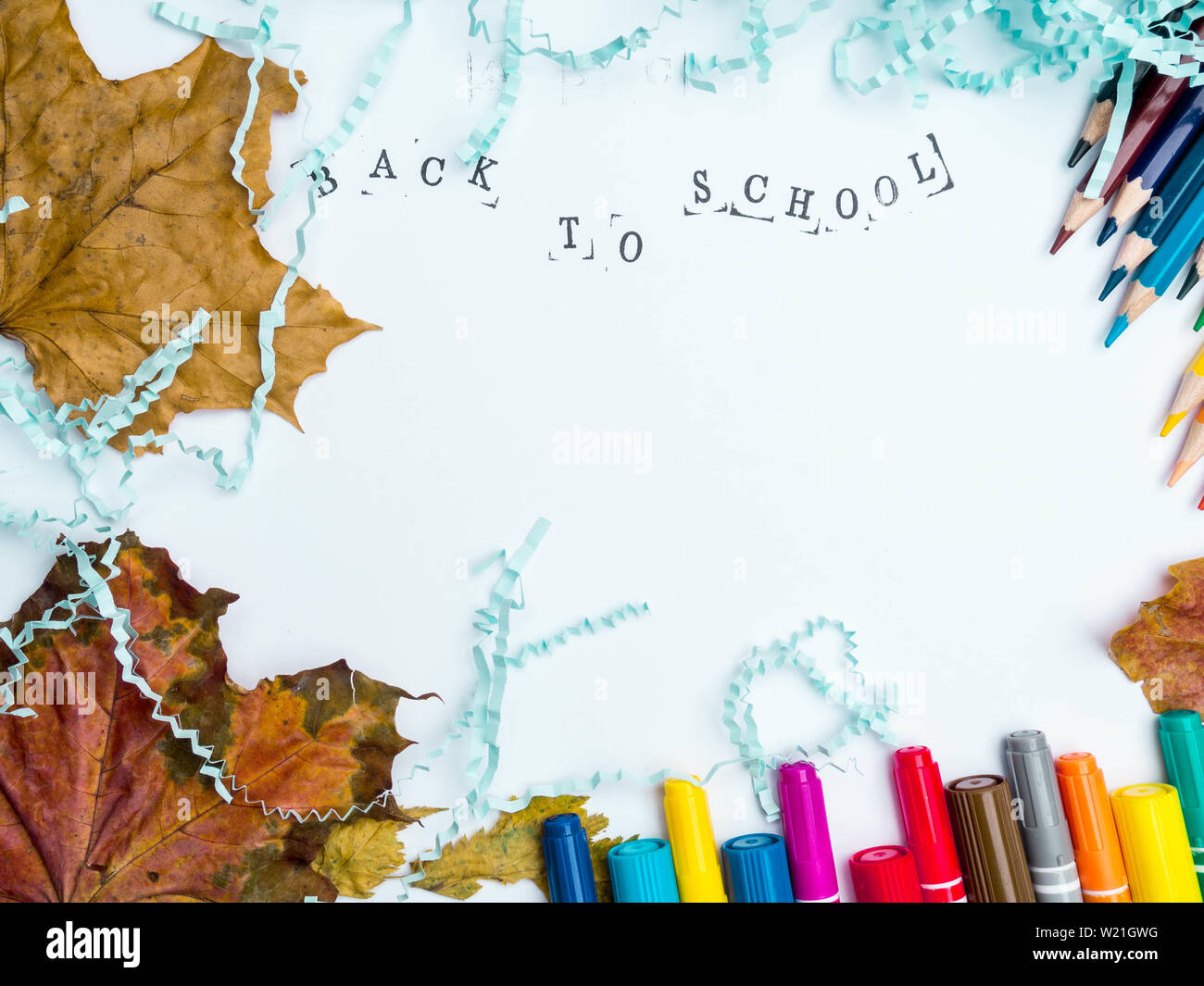 Stamped Inscription back to school with markers, pencils, blue literal ...