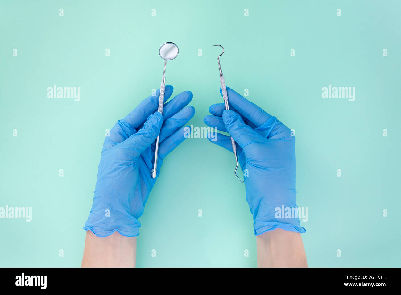 Dentist in medical gloves working with professional stomatology tools . Dental hygiene and health concept Stock Photo