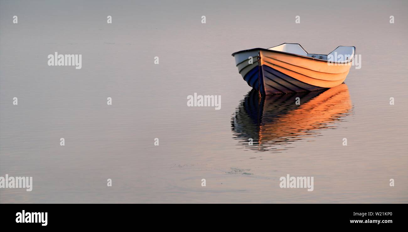 Evening atmosphere at Lake Kummerow, boat anchored, pastel colours, Mecklenburg-Western Pomerania, Germany Stock Photo