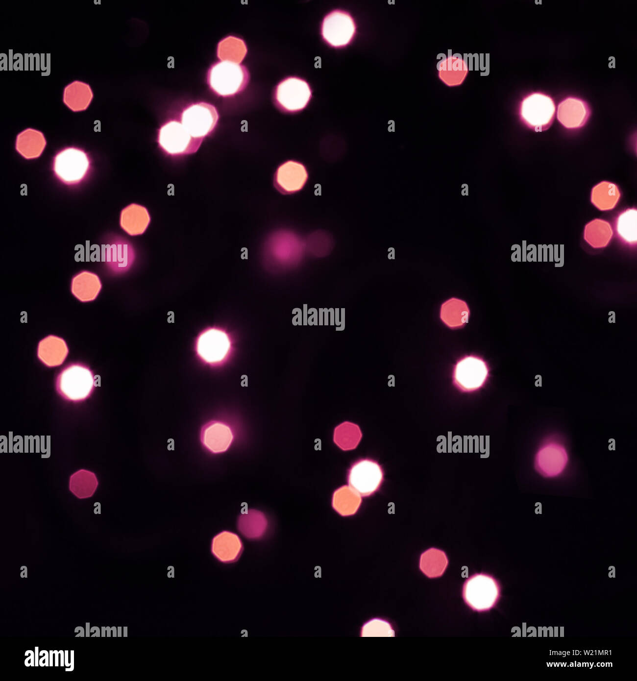Falling purple bokeh lights in hexagon shape on black. Holiday concept ...