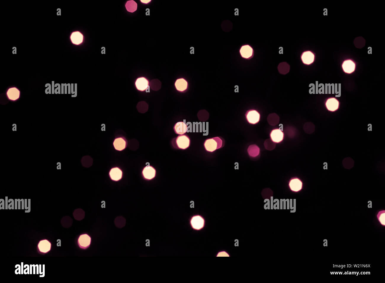 Black festive background with shining hexagonal bokeh lights. Stock Photo