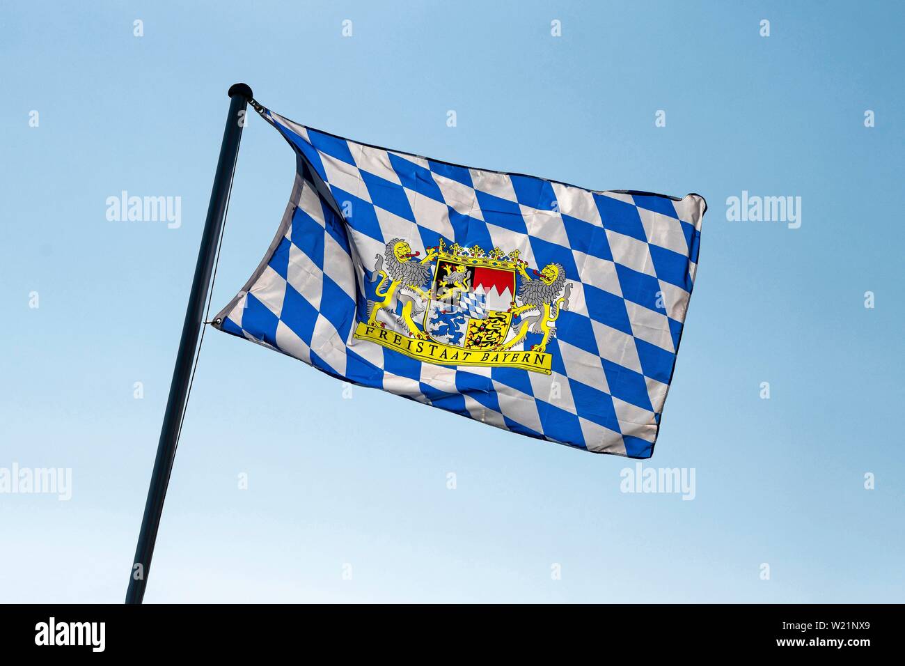 Blue-white flag with coat of arms of the Free State of Bavaria blowing in the wind, Markt Swabia, Bayern, Oberbayern, Germany Stock Photo