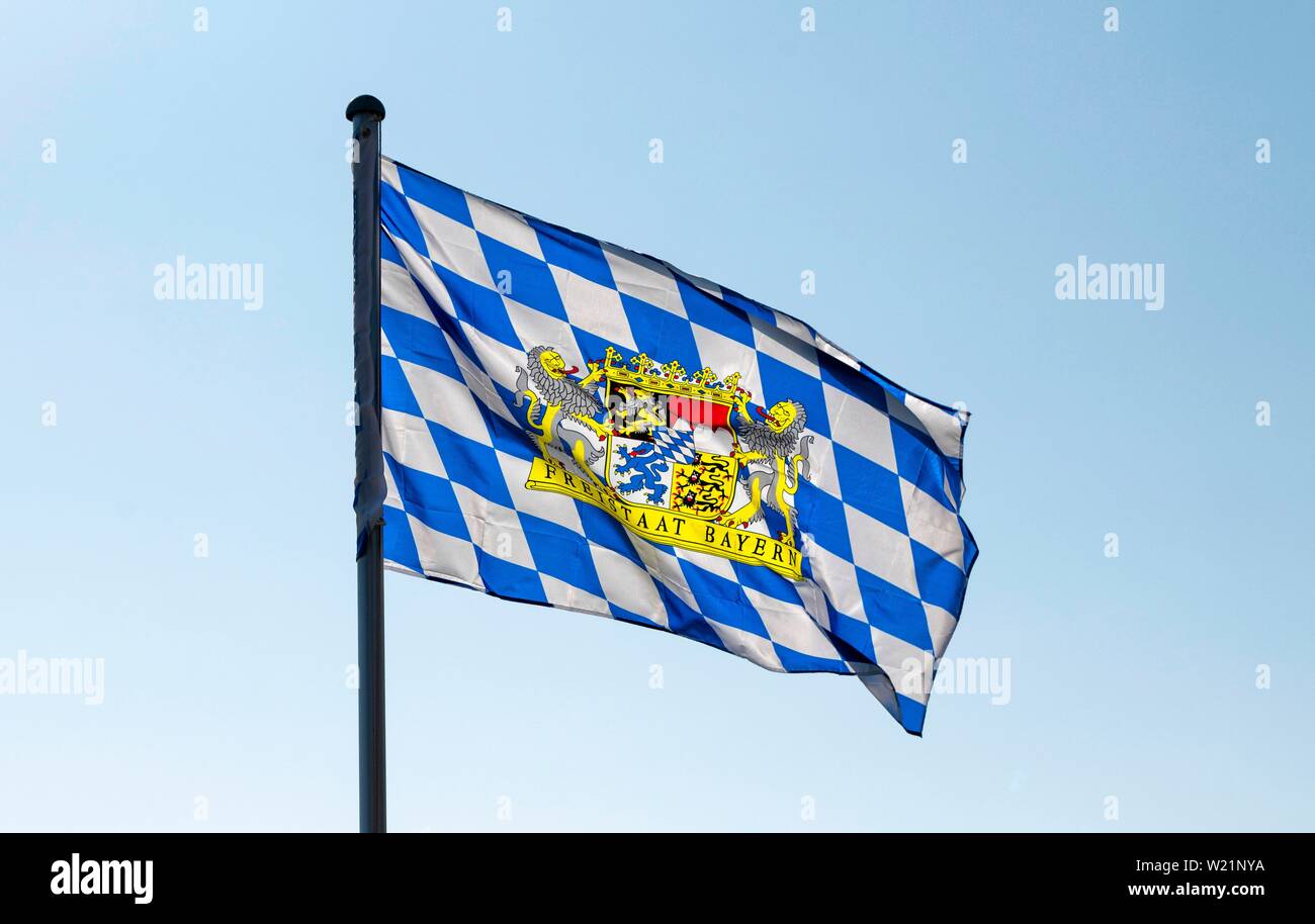 A blue-white flag with the coat of arms of the Free State of Bavaria blows in the wind in Markt Swabia, Bavaria, Germany Stock Photo