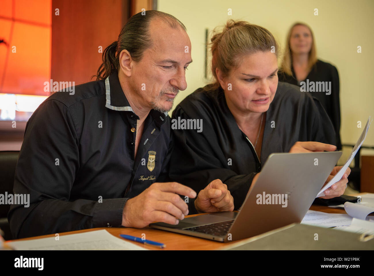 Hof, Germany. 05th July, 2019. The defendant Peter Fitzek sits next to his lawyer Christin Konrad (M). The trial against the self-proclaimed 'King of Germany' for driving without a driving licence continues. The accused, who is assigned to the Reich citizens' scene by the Verfassungsschutz, had returned his driving license and made his own permit. Credit: Nicolas Armer/dpa/Alamy Live News Stock Photo