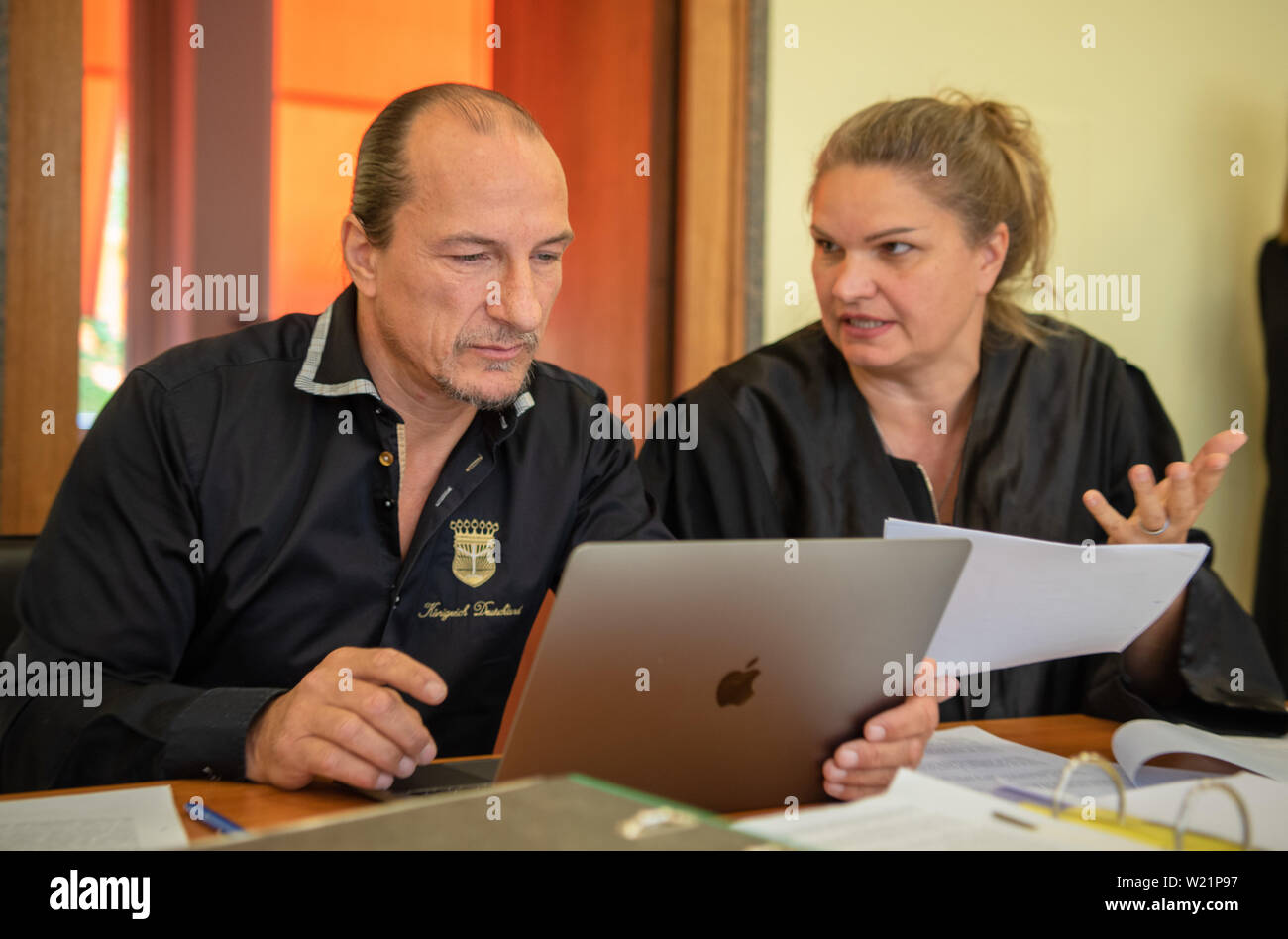 Hof, Germany. 05th July, 2019. The defendant Peter Fitzek sits next to his lawyer Christin Konrad (M). The trial against the self-proclaimed 'King of Germany' for driving without a driving licence continues. The accused, who is assigned to the Reich citizens' scene by the Verfassungsschutz, had returned his driving license and made his own permit. Credit: Nicolas Armer/dpa/Alamy Live News Stock Photo