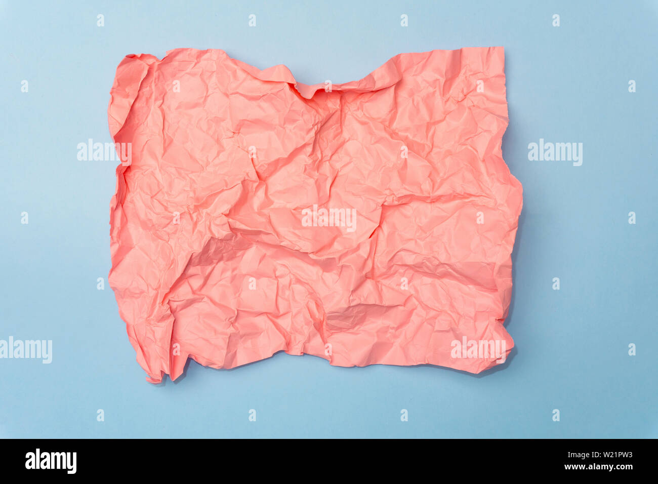 Crumpled paper minimal concept. Сolored pastel paper on a colored background. Stock Photo