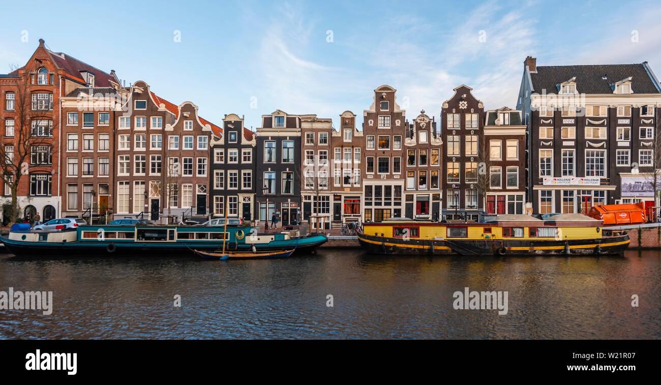 Canal with boats, historical row of houses on the Singel Gracht, Amsterdam, North Holland, Netherlands Stock Photo