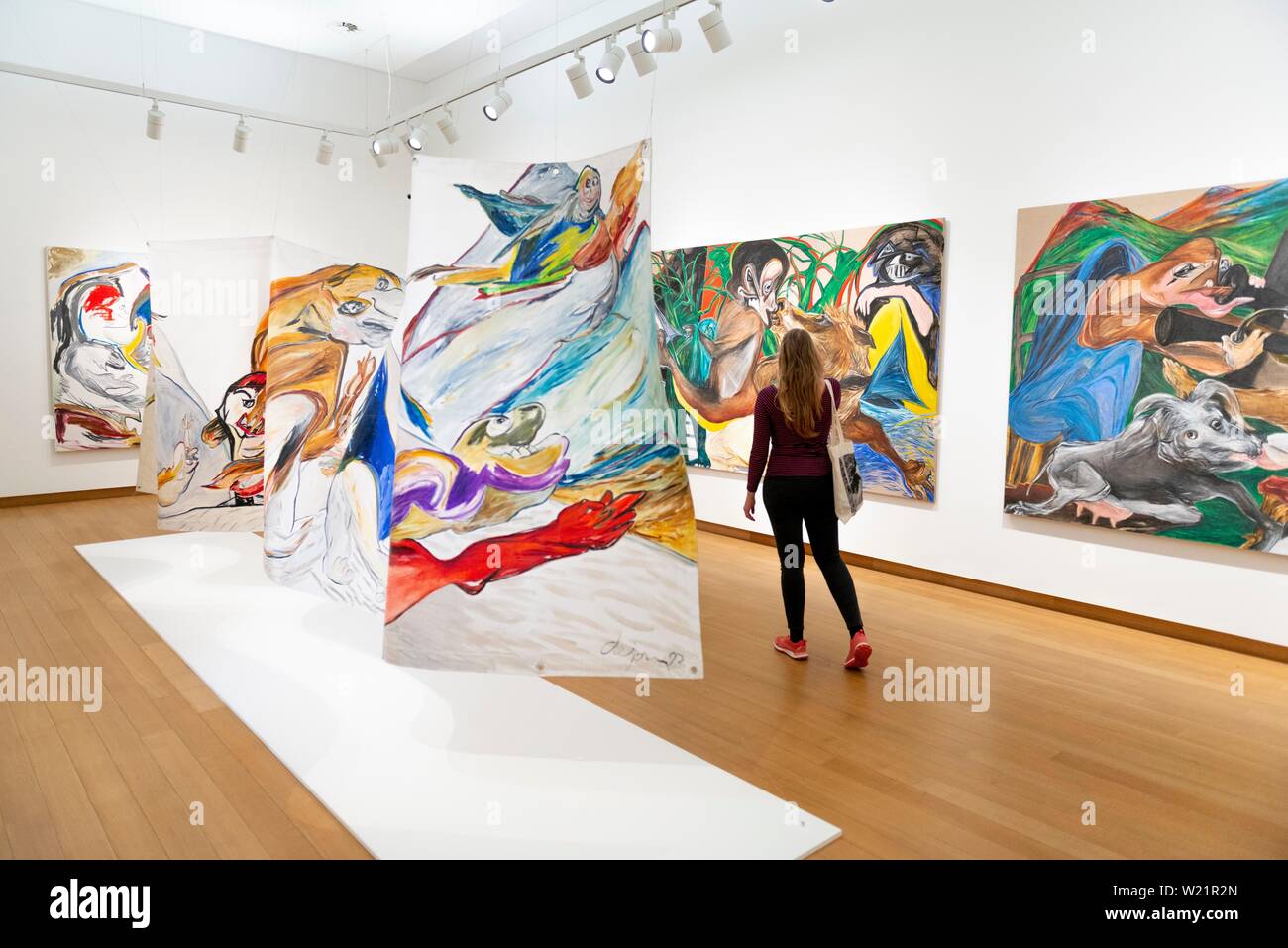 Visitor looks at modern paintings, exhibition space at Stedelijk Museum
