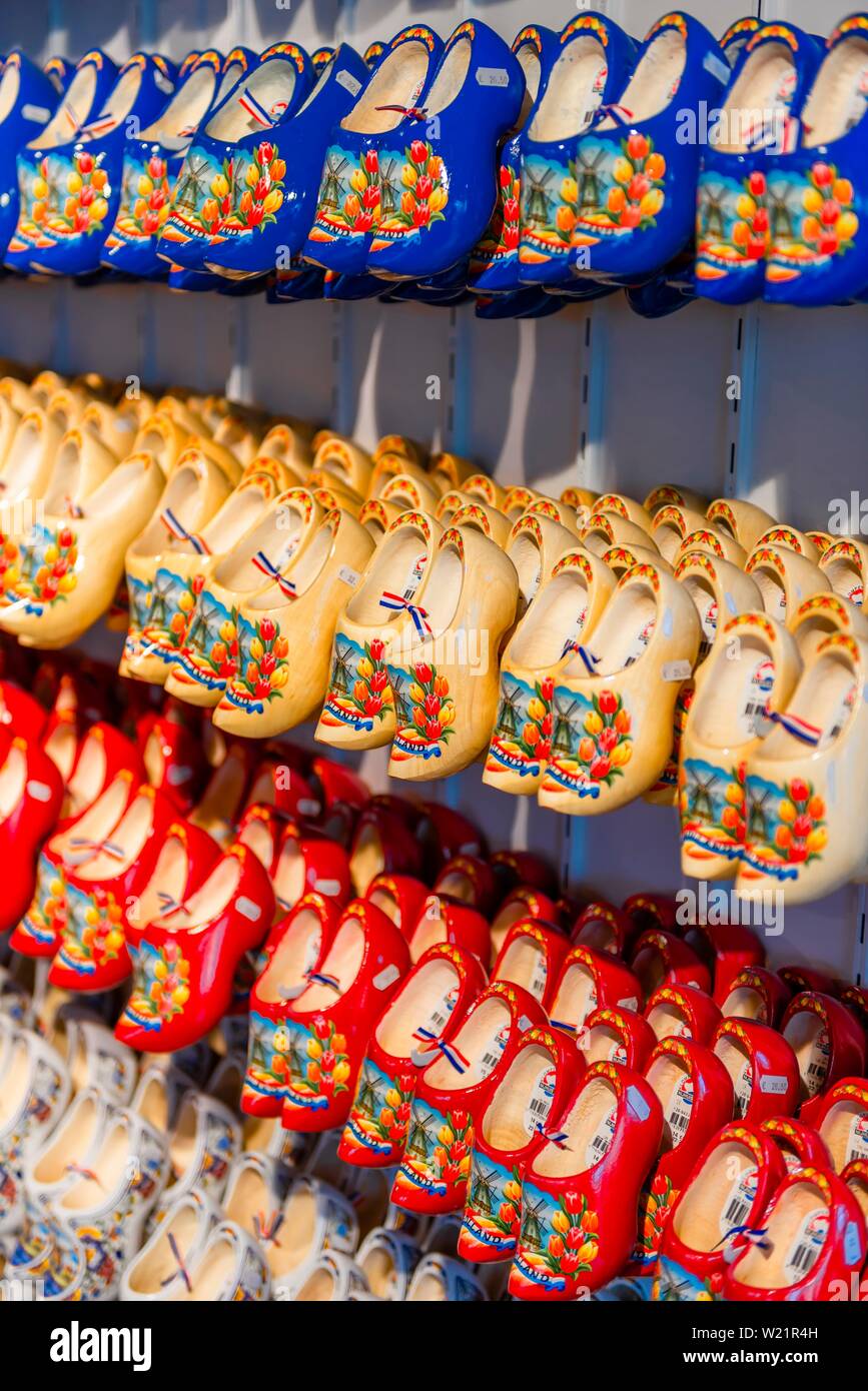Traditionally colorfully painted Dutch wooden shoes on rack for sale