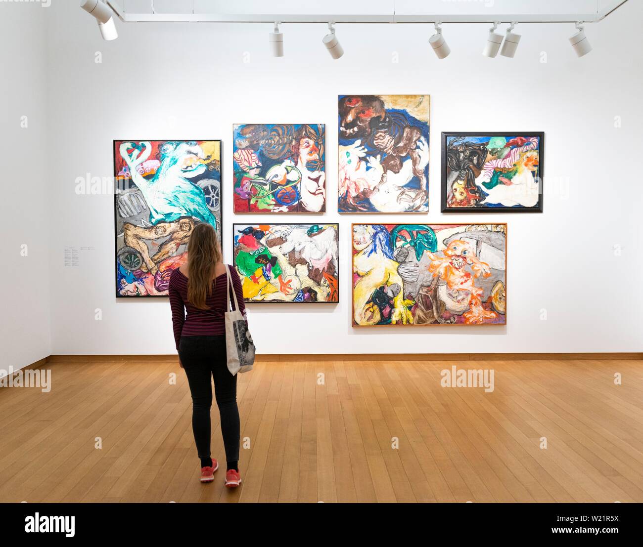 Visitor looks at modern paintings, exhibition space at Stedelijk Museum