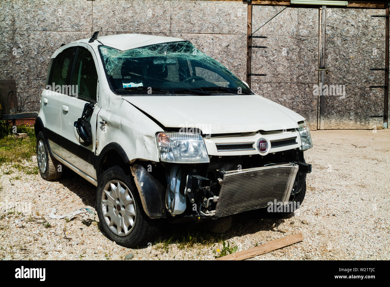 Vintage white Fiat Uno car parked destroyed after a crash accident in a  urban scenario. Florence, Italy Stock Photo - Alamy