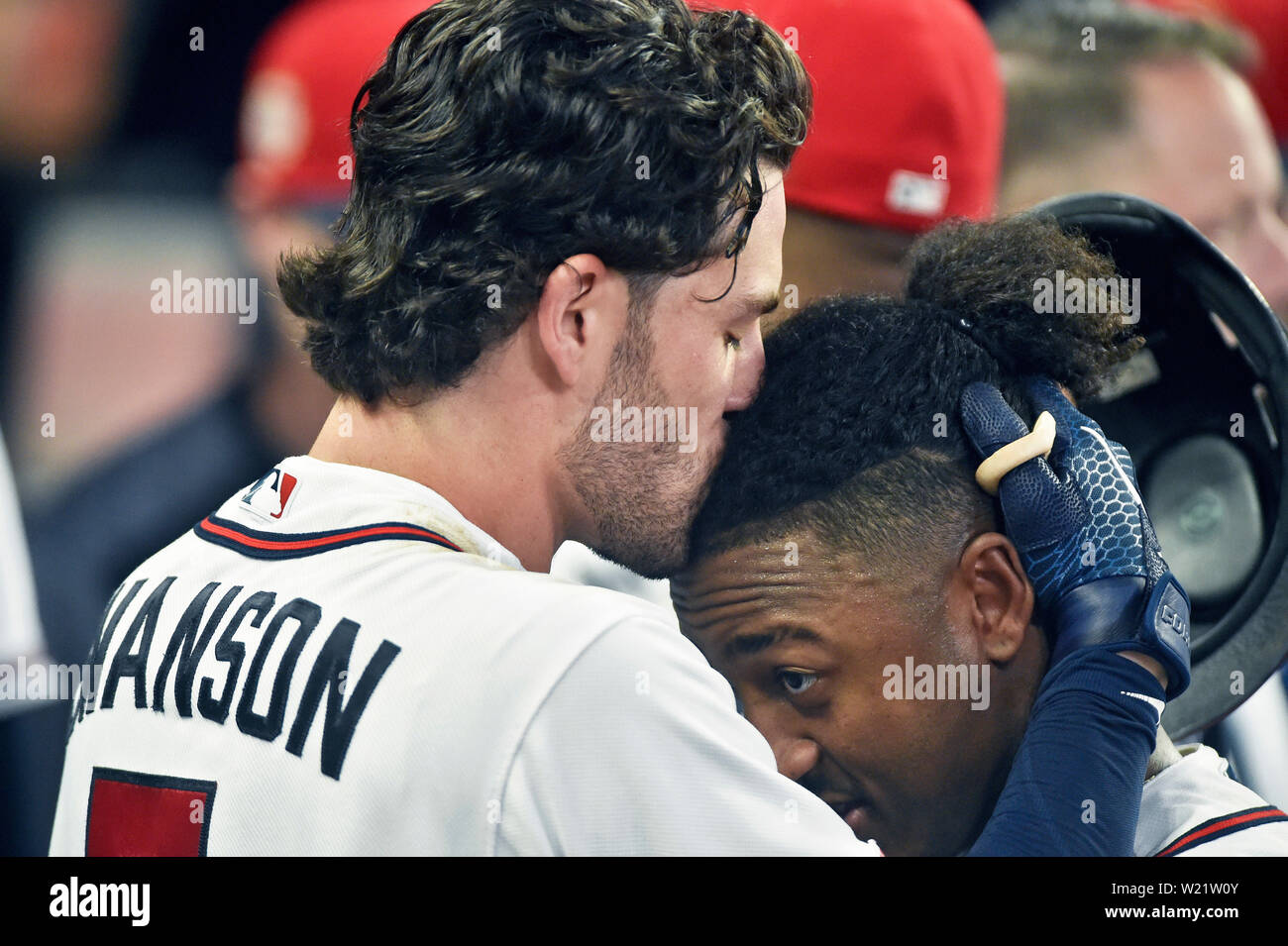 Atlanta, GA, USA. 04th July, 2019. Atlanta Braves shortstop Dansby Swanson  (left) kisses the head of infielder Ozzie Albies (right) after hitting an  eighth inning home run during a MLB game against