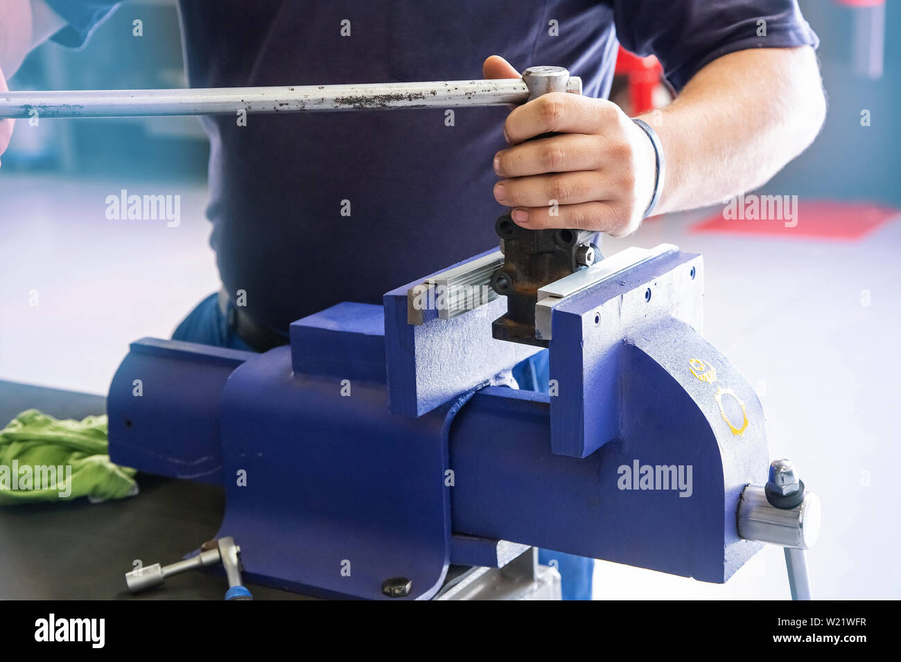 Engineer using wrench and vice grip to tighten bolt in Stock