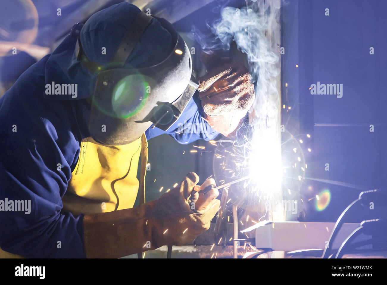 Man welding in workshop. Arc welding. Stock Photo