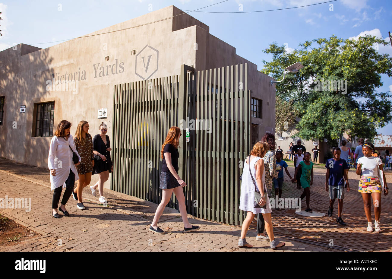 Johannesburg, South Africa, 30th March - 2019: People walking into entrance gate of inner city redevelopment project. Stock Photo