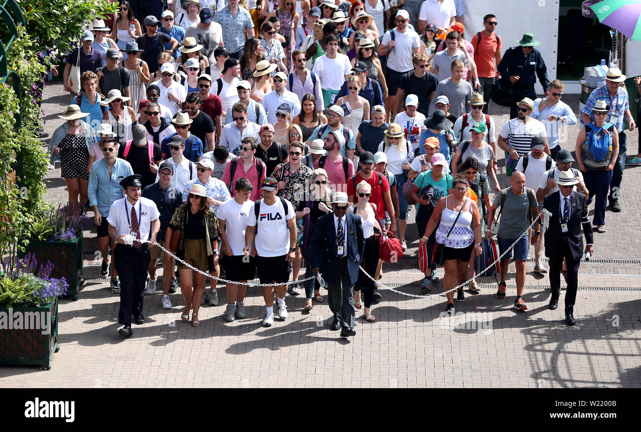 Spectators are led into the grounds at the start of day five of the Wimbledon Championships at the All England Lawn Tennis and Croquet Club, Wimbledon. Stock Photo