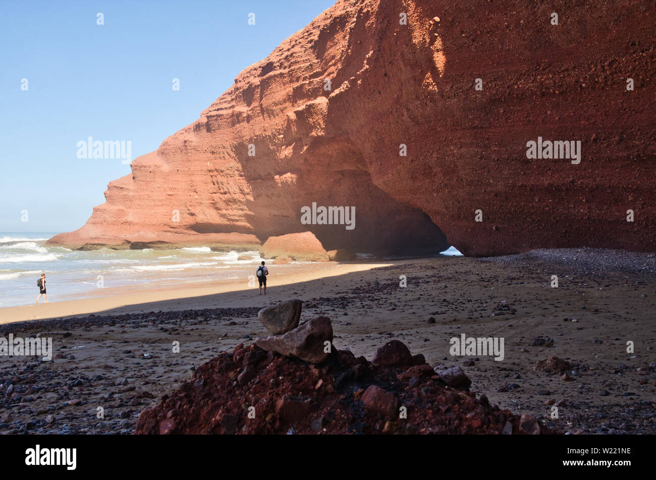 Red rock formation with arch on the beach, Plage Sidi Ifni, Morocco, Africa Stock Photo