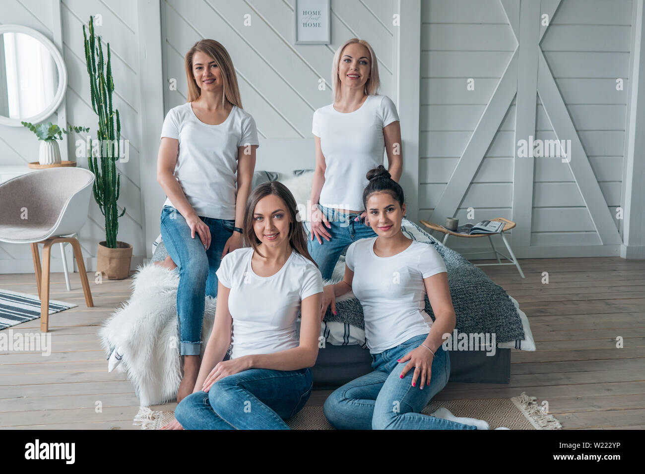 The layout of the logo on a white t-shirt. Young beautiful girl models in casual clothes. Stock Photo