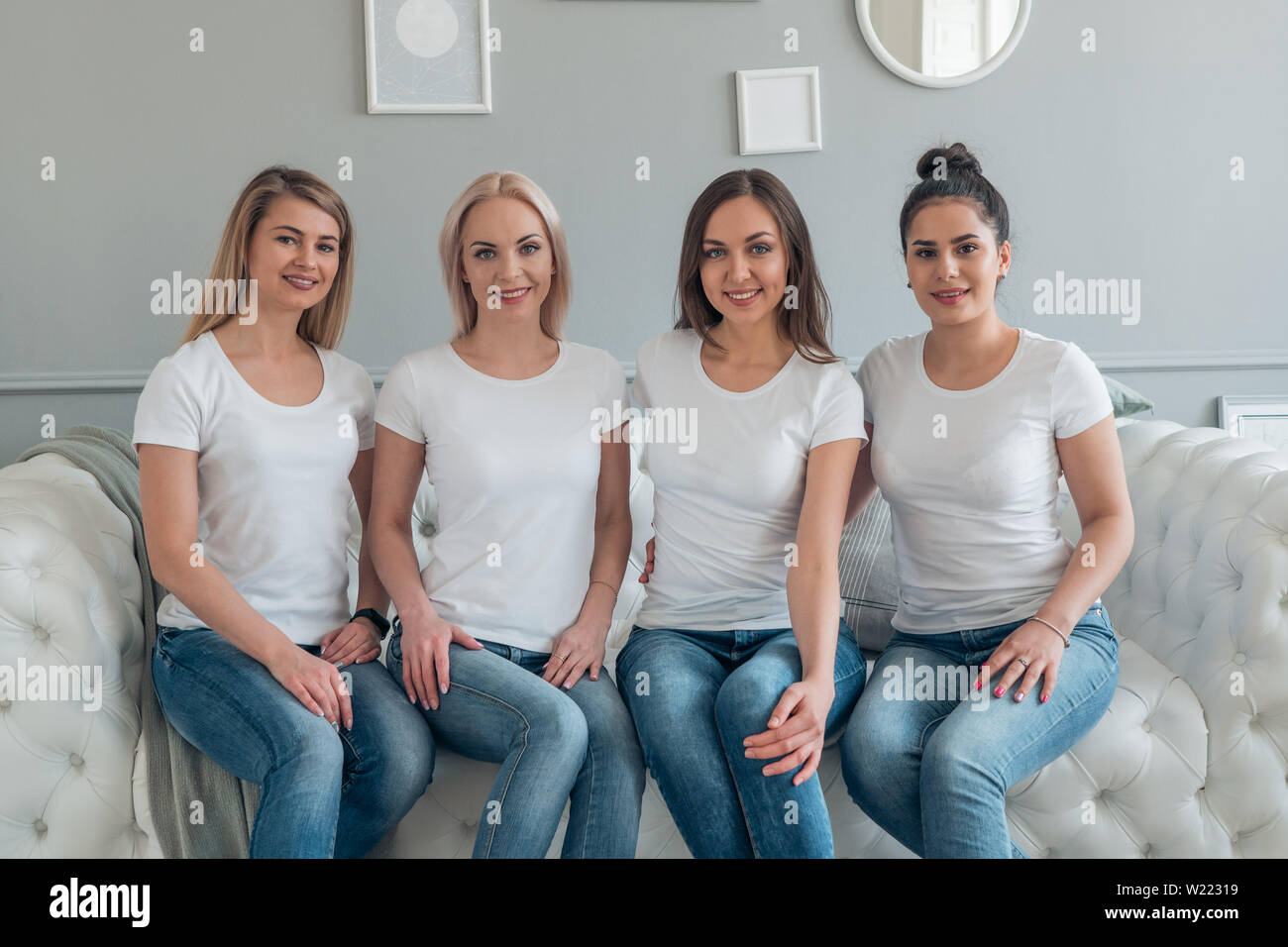 Slender beautiful girls in white t-shirts and jeans. Casting in modeling Agency Stock Photo