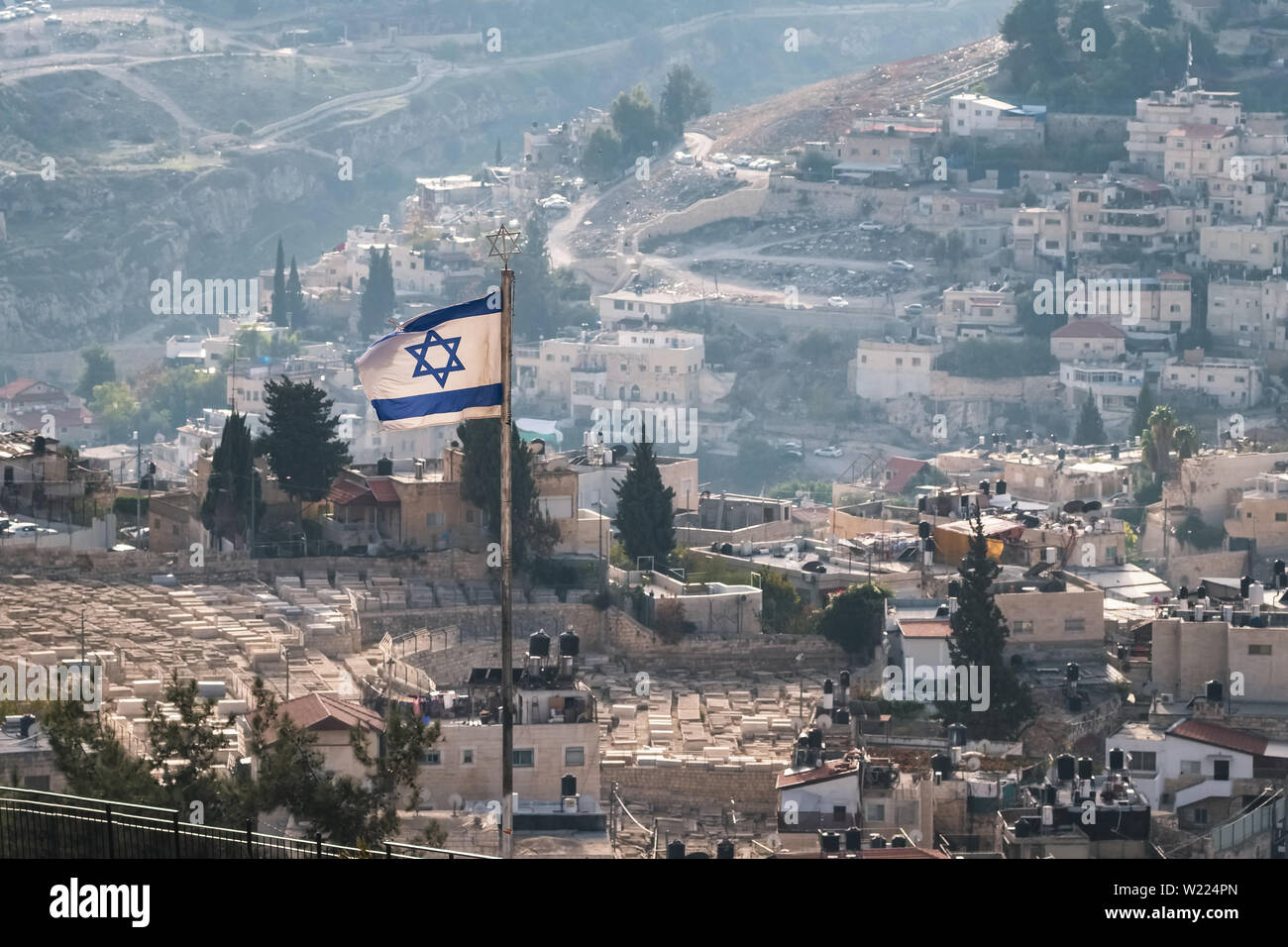 Israeli flag with residential buildings at background in Jerusalem, Israel Stock Photo