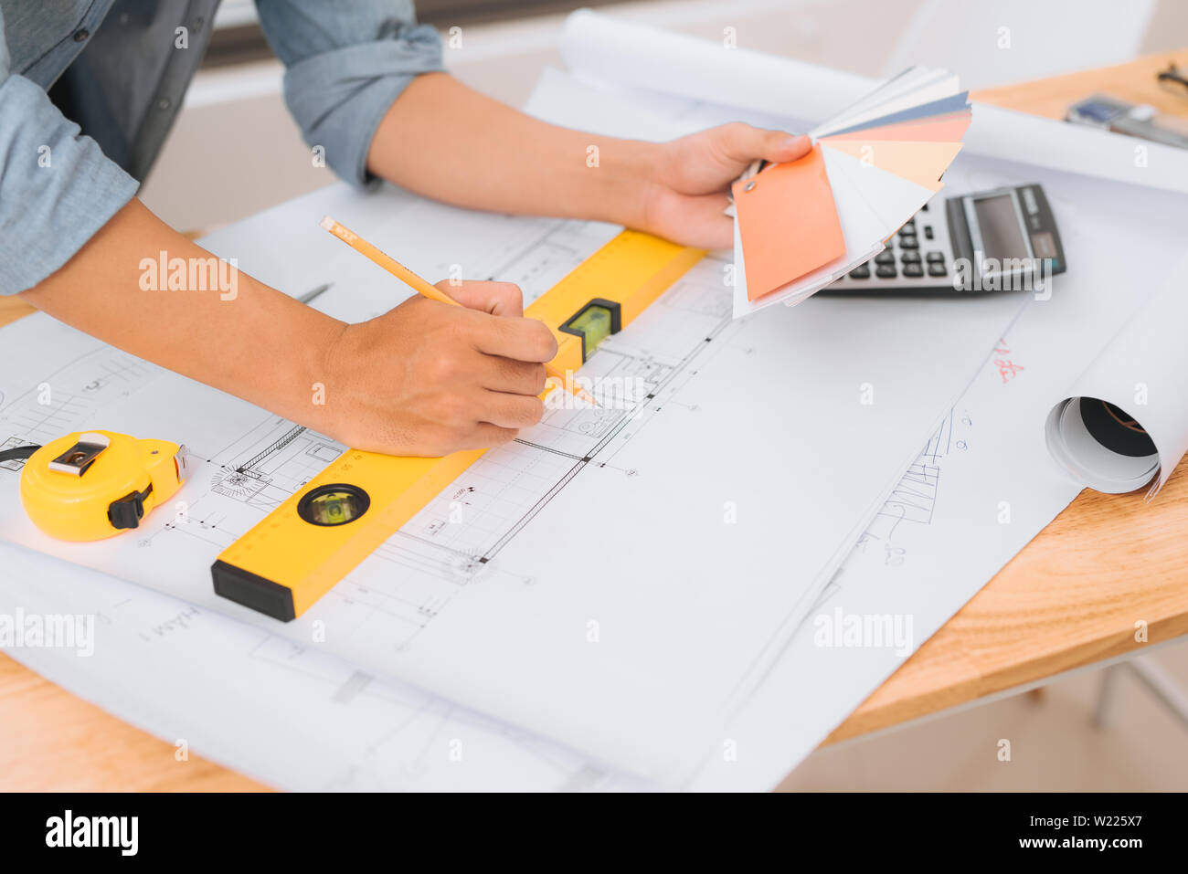 Workplace items tools for project, Architect or Engineer working on blueprint for architectural project in progress, construction and structure concep Stock Photo