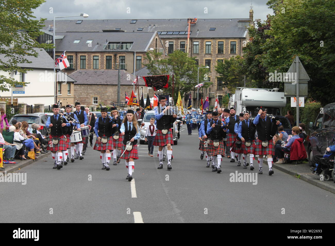 A pipe band marches up the street in Comber for Black Saturday celebrations Stock Photo