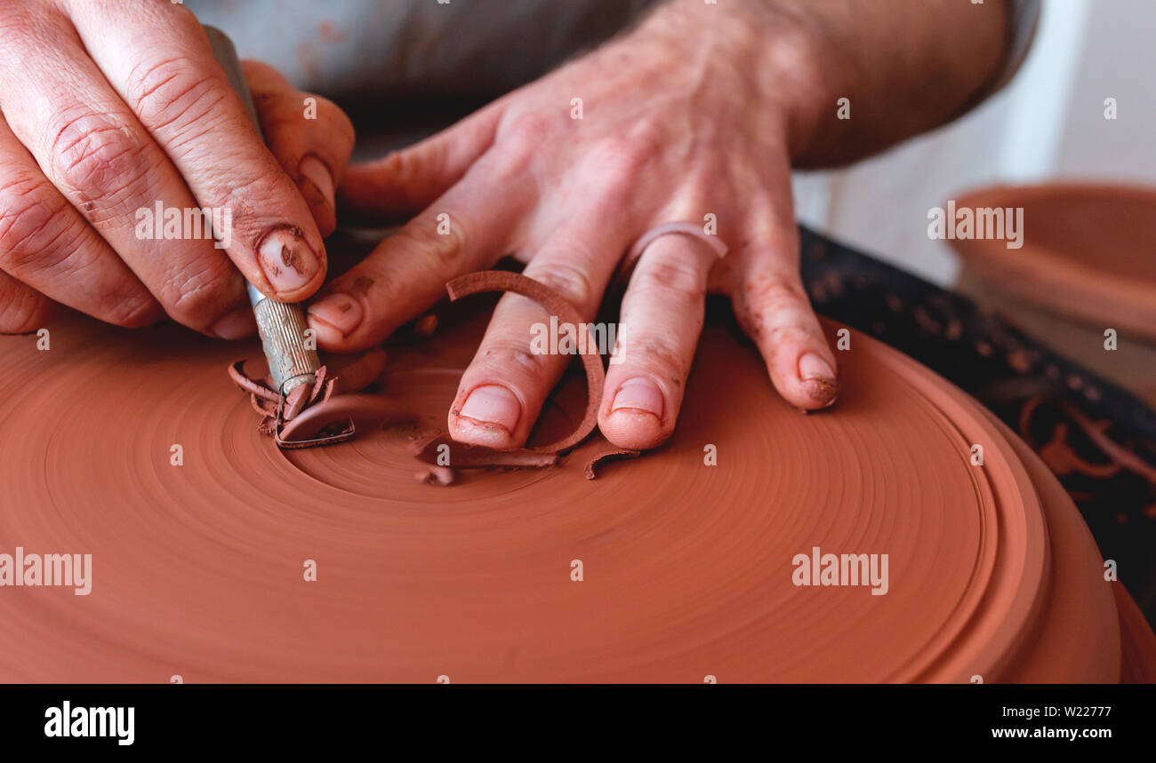 Professional potter making bowl in pottery studio Stock Photo
