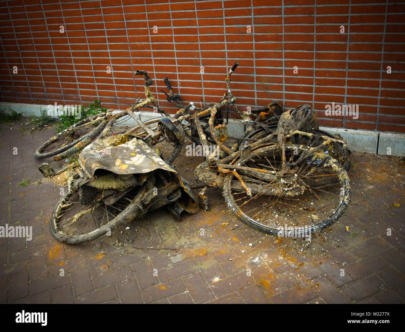Bicycles pulled out of canal in Amsterdam. Old and rusty bikes piled up in street. Stock Photo